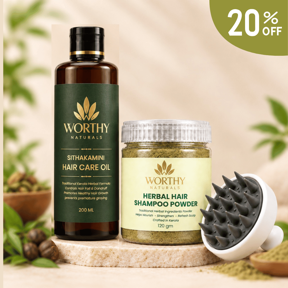 Worthy Naturals hair care set featuring a 200ml bottle of Sithakamini Hair Care Oil, a jar of Herbal Hair Shampoo Powder, and a black-and-white scalp massager, arranged on a wooden slice with herbs and a green 20% off badge.